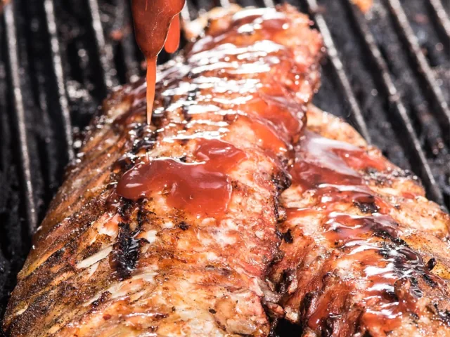 Barbecued baby back ribs on the grill
