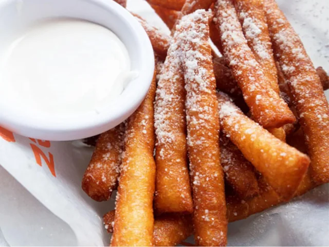 Sugar-dusted funnel cake fries with dip