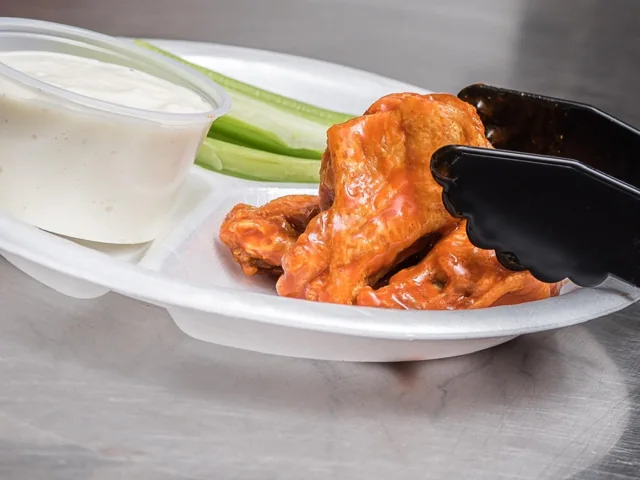 Buffalo wings with celery and dip; wings shown